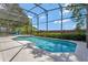 Screened pool area featuring a pool with an integrated spa and well-maintained landscaping at 12411 Scarlett Sage Ct, Winter Garden, FL 34787