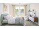 Bright, minimalist bedroom with a modern bed, an adjacent balcony, and stylish decorations at 12536 Westhaven Oak Dr # 111, Winter Garden, FL 34787