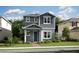 Charming two-story home with blue accents, a well-manicured lawn, and inviting curb appeal at 12536 Westhaven Oak Dr # 111, Winter Garden, FL 34787