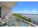 Balcony view overlooking a pool and lake, with outdoor seating available for residents to relax at 13415 Blue Heron Beach Dr # 710, Orlando, FL 32821