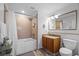 Cozy bathroom featuring a shower-tub combo with a mosaic tile backsplash and a vanity area at 13415 Blue Heron Beach Dr # 710, Orlando, FL 32821
