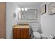 Bright bathroom featuring a vanity with a mirror, a toilet, and a hairdryer at 13415 Blue Heron Beach Dr # 710, Orlando, FL 32821