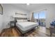 Bedroom featuring a large bed, wood-look floors, and a sliding door leading to a balcony at 13415 Blue Heron Beach Dr # 710, Orlando, FL 32821