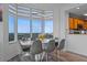 Bright dining room featuring a contemporary table setting, unique lighting fixture, and expansive window views at 13415 Blue Heron Beach Dr # 710, Orlando, FL 32821