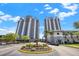 Beautiful condo building exterior view with manicured landscape and inviting entrance on a clear and sunny day at 13415 Blue Heron Beach Dr # 710, Orlando, FL 32821