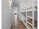 Hallway featuring a bunk bed with white frames and hardwood floors at 13415 Blue Heron Beach Dr # 710, Orlando, FL 32821