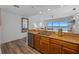 Modern kitchen featuring stainless steel appliances, wood cabinets, granite countertops and a view of the living area at 13415 Blue Heron Beach Dr # 710, Orlando, FL 32821