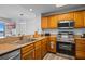 A well-lit kitchen with stainless steel appliances and wood finish cabinets at 13415 Blue Heron Beach Dr # 710, Orlando, FL 32821
