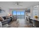 Bright living room featuring modern decor, a ceiling fan, and a sliding glass door to a balcony with water views at 13415 Blue Heron Beach Dr # 710, Orlando, FL 32821