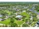 Aerial view featuring a community pool and clubhouse surrounded by lush landscaping at 14526 Chicora Crossing Blvd, Orlando, FL 32828
