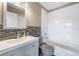 Bathroom with tub and shower, vanity with mosaic backsplash and neutral color scheme at 14526 Chicora Crossing Blvd, Orlando, FL 32828
