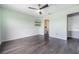 Spacious bedroom with natural light, featuring a ceiling fan and hardwood flooring at 14526 Chicora Crossing Blvd, Orlando, FL 32828