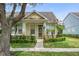 Charming yellow single-Gathering home with manicured lawn and lush landscaping at 14526 Chicora Crossing Blvd, Orlando, FL 32828