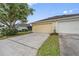 Attached two-car garage with a concrete driveway and well-maintained landscaping at 14526 Chicora Crossing Blvd, Orlando, FL 32828