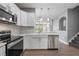 Bright kitchen featuring white cabinets, stainless steel appliances, and an open concept design at 14526 Chicora Crossing Blvd, Orlando, FL 32828