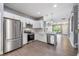 Modern kitchen with stainless steel appliances, white cabinets, and an open concept layout at 14526 Chicora Crossing Blvd, Orlando, FL 32828