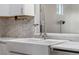 Close-up of a modern farmhouse kitchen sink with a stylish faucet and white countertops at 14526 Chicora Crossing Blvd, Orlando, FL 32828