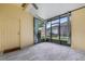 A relaxing screened porch with wood-look gray tile flooring and views of the outdoor landscape at 14526 Chicora Crossing Blvd, Orlando, FL 32828