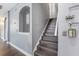 Elegant stairway with wood steps, gray walls and charming alcove is well decorated at 14526 Chicora Crossing Blvd, Orlando, FL 32828