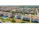 Aerial view showing houses with beautiful landscaping and the community lake at 14962 Fells Ln, Orlando, FL 32827