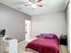 Simple bedroom with a comfortable bed, desk, and neutral-colored walls, ideal for relaxation at 14962 Fells Ln, Orlando, FL 32827