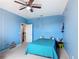 Charming blue bedroom features a cozy bed, ceiling fan, and cheerful decorations at 14962 Fells Ln, Orlando, FL 32827