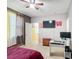 Inviting bedroom with a ceiling fan, a desk area, and a large window for natural light at 14962 Fells Ln, Orlando, FL 32827