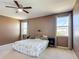 Tranquil bedroom with two windows, ceiling fan, and warm-toned walls, creating a cozy retreat at 14962 Fells Ln, Orlando, FL 32827