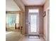 Inviting foyer featuring a decorative glass door and neutral color palette, creating a warm welcome at 14962 Fells Ln, Orlando, FL 32827