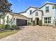 A well maintained two-story home featuring a two-car garage and brick driveway at 14962 Fells Ln, Orlando, FL 32827