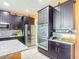 Modern kitchen with stainless steel appliances, dark cabinetry, and granite counters at 14962 Fells Ln, Orlando, FL 32827