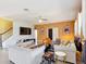 Open-concept living room with tile flooring, stylish decor, and ample natural light at 14962 Fells Ln, Orlando, FL 32827