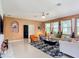 Comfortable living room with tile floors, neutral sofas, and abundant natural light at 14962 Fells Ln, Orlando, FL 32827