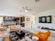 Bright living room featuring tile floors, modern sofas, and open layout to kitchen at 14962 Fells Ln, Orlando, FL 32827