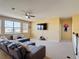 Cozy living room with a large window, ceiling fan, comfortable seating and a flat-screen television at 14962 Fells Ln, Orlando, FL 32827