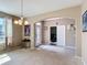 Inviting living room with neutral walls, an arched entry, and carpet flooring at 14962 Fells Ln, Orlando, FL 32827