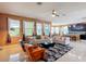 Spacious open living room with tiled floors, modern furnishings, and natural light at 14962 Fells Ln, Orlando, FL 32827