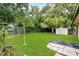 Serene backyard with a lush lawn, privacy fence, and a storage shed, creating a peaceful outdoor space at 157 Ambergate Ct, Debary, FL 32713