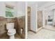 Neutral bathroom with tiled walls, a walk-in shower, toilet, and built-in storage at 157 Ambergate Ct, Debary, FL 32713