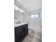 Well-lit bathroom featuring a modern vanity and a tiled shower/tub combination at 157 Ambergate Ct, Debary, FL 32713