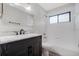 Stylish bathroom featuring black vanity, white counter, modern fixtures and shower-tub combo at 157 Ambergate Ct, Debary, FL 32713