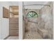 This bathroom features a shower with window, built-in storage and tiled walls at 157 Ambergate Ct, Debary, FL 32713