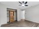 Bright bedroom featuring a ceiling fan and an organized closet at 157 Ambergate Ct, Debary, FL 32713