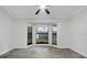 Bright bedroom featuring light gray floors, a ceiling fan, and bay window at 157 Ambergate Ct, Debary, FL 32713