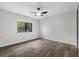 Neutral bedroom space with sleek floors, window, and ceiling fan at 157 Ambergate Ct, Debary, FL 32713