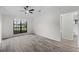 Bright bedroom with a ceiling fan, large window, and ensuite bathroom access at 157 Ambergate Ct, Debary, FL 32713