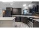 Modern kitchen with dark cabinets, stainless steel appliances, and an island at 157 Ambergate Ct, Debary, FL 32713
