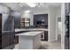Modern kitchen featuring stainless appliances, a large island, and stylish cabinets at 157 Ambergate Ct, Debary, FL 32713