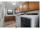 Efficient laundry room equipped with modern appliances and ample cabinet space at 157 Ambergate Ct, Debary, FL 32713