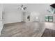 Bright and spacious living room with light floors, ceiling fans and view of the kitchen at 157 Ambergate Ct, Debary, FL 32713